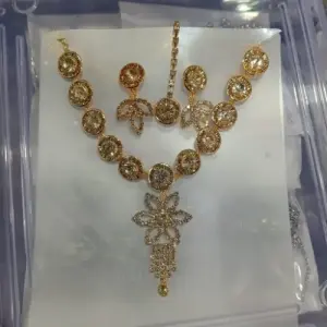 Gold with white stone neckpiece and earrings and mangteeka